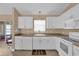 Well-lit kitchen features white cabinetry and modern appliances at 1029 Soledad Way, The Villages, FL 32159