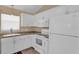 The well-equipped kitchen features white appliances and ample counter space at 1029 Soledad Way, The Villages, FL 32159