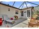 Outdoor patio space with comfortable seating areas and serene views of the landscaped backyard at 1029 Soledad Way, The Villages, FL 32159