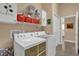 Functional laundry room equipped with washer, dryer, and shelving at 1029 Soledad Way, The Villages, FL 32159