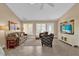 Inviting living room featuring comfortable seating, tile flooring, and bright natural light at 1029 Soledad Way, The Villages, FL 32159