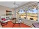 Bright sunroom featuring large picture windows with views of the lush backyard and nearby golf course at 1029 Soledad Way, The Villages, FL 32159