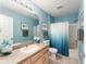 Bright bathroom featuring a shower/tub combo, vanity, and tiled floors at 1100 Blythe Way, The Villages, FL 32162