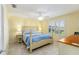 Bright bedroom with a four-poster bed, ceiling fan, tile floors and a window with plantation shutters at 1100 Blythe Way, The Villages, FL 32162