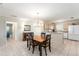 Dining area featuring tiled floors, chandelier lighting, and convenient access to kitchen and bathroom at 1100 Blythe Way, The Villages, FL 32162