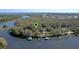 Aerial view of the home on the water with multiple docks at 11215 Dead River Rd, Tavares, FL 32778