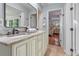 This bathroom features an updated countertop, double sink, and tiled floors at 11215 Dead River Rd, Tavares, FL 32778