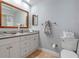 This bathroom features double sinks, a large mirror, and white cabinets at 11215 Dead River Rd, Tavares, FL 32778