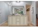 Bathroom featuring double sinks, granite countertops, tiled shower, and a large mirror at 11215 Dead River Rd, Tavares, FL 32778