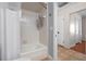 This bathroom features tile floors, white tiles on the shower walls, and a bathtub at 11215 Dead River Rd, Tavares, FL 32778