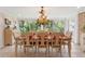 Bright dining room featuring stylish chandelier, and view of lush greenery at 11215 Dead River Rd, Tavares, FL 32778