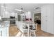 Stylish kitchen featuring white cabinets, stainless steel appliances, and an island with barstool seating at 11215 Dead River Rd, Tavares, FL 32778