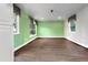 Open living room featuring wood floors, ample natural light from multiple windows, and neutral green wall color at 11215 Dead River Rd, Tavares, FL 32778