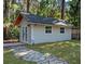 This is a small outbuilding with double doors and a stone walkway at 11215 Dead River Rd, Tavares, FL 32778