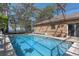 Screened pool in brick enclosure with seating area at 11215 Dead River Rd, Tavares, FL 32778