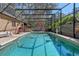Enclosed pool and screened enclosure provide an outdoor living area with a grill and entertaining space at 11215 Dead River Rd, Tavares, FL 32778