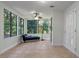 This sunroom features lots of windows, a ceiling fan, and tile flooring at 11215 Dead River Rd, Tavares, FL 32778
