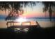Breathtaking sunset view from a dock over the calm waters, creating a serene ambiance at 11215 Dead River Rd, Tavares, FL 32778