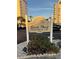 Sands Point Condominium sign with manicured landscaping and view of the community building at 1167 Ocean Shore Blvd # 30, Ormond Beach, FL 32176