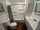 Cozy bathroom featuring white vanity, toilet, shower, tub, and modern fixtures at 11701 Layton St, Leesburg, FL 34788