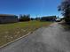 Home and large garage on an expansive lawn with a paved driveway at 11701 Layton St, Leesburg, FL 34788