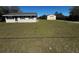 Exterior view of home and detached garage on a sprawling green lawn at 11701 Layton St, Leesburg, FL 34788