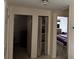 Hallway with multiple open doorways leading to bedrooms and closet, showing ease of access at 11701 Layton St, Leesburg, FL 34788