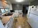 Functional kitchen with white cabinets, laminate countertops, and essential appliances at 11701 Layton St, Leesburg, FL 34788