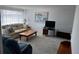 Cozy living room featuring neutral walls, comfortable seating, and natural light at 11701 Layton St, Leesburg, FL 34788