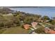 Stunning aerial view of waterfront homes with lush greenery and beautiful landscaping near the lake at 12127 Cypress Landing Ave, Clermont, FL 34711
