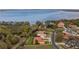 An aerial view that showcases a beautiful waterfront property, boasting a well-manicured lawn and a tile roof at 12127 Cypress Landing Ave, Clermont, FL 34711