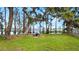 Scenic backyard with picnic table and waterfront views framed by trees draped with Spanish moss at 12127 Cypress Landing Ave, Clermont, FL 34711