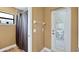 Bathroom with a shower, window, and an exit door to the outside of the home at 12127 Cypress Landing Ave, Clermont, FL 34711