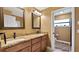 Bathroom showcasing a double sink vanity with granite countertop and modern fixtures at 12127 Cypress Landing Ave, Clermont, FL 34711