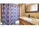Bathroom features a granite countertop, shower with patterned shower curtain and modern fixtures at 12127 Cypress Landing Ave, Clermont, FL 34711
