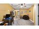 Bedroom features neutral carpeting, ceiling fan, and is adjacent to the hall and other rooms at 12127 Cypress Landing Ave, Clermont, FL 34711