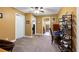 Bedroom featuring neutral carpeting, ceiling fan, and is adjacent to the bathroom and other rooms at 12127 Cypress Landing Ave, Clermont, FL 34711