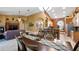 Open-concept dining room and kitchen featuring warm tones, tile floors, and bar seating at the kitchen counter at 12127 Cypress Landing Ave, Clermont, FL 34711