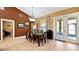 Elegant dining room with ample seating, a glass cabinet, and doors leading to the patio, ideal for entertaining at 12127 Cypress Landing Ave, Clermont, FL 34711