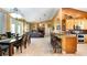 Open concept kitchen and living area with tile flooring, wooden cabinets, and a breakfast bar at 12127 Cypress Landing Ave, Clermont, FL 34711