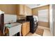 Spacious laundry room features a utility sink, counter space, and modern washer and dryer set at 12127 Cypress Landing Ave, Clermont, FL 34711