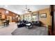 Bright, spacious living room with a fireplace, kitchen access and comfortable seating for entertaining at 12127 Cypress Landing Ave, Clermont, FL 34711