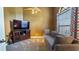 Cozy living room with a comfortable sofa, TV, and large window, creating a relaxing atmosphere at 12127 Cypress Landing Ave, Clermont, FL 34711