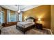 Comfortable bedroom with a ceiling fan, a cozy bed, and a large window, offering a restful retreat at 12127 Cypress Landing Ave, Clermont, FL 34711