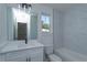 Elegant bathroom with white marble tile, dual vanity, and modern fixtures, creating a spa-like atmosphere at 1307 E Harding St, Orlando, FL 32806