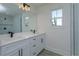 Bathroom features dual vanity, sleek black fixtures, and a luxurious shower, creating a spa-like space at 1307 E Harding St, Orlando, FL 32806