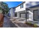 Contemporary home featuring a paved driveway leading to gray garage doors and a modern front door at 1307 E Harding St, Orlando, FL 32806