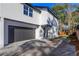 A modern home showcasing a two-car gray garage, a gray door, and stylish paved driveway at 1307 E Harding St, Orlando, FL 32806
