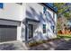 Stunning modern two-story home featuring a gray door, paved driveway, and minimalist landscaping at 1307 E Harding St, Orlando, FL 32806