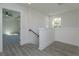 Hallway with modern vinyl floors, and an open doorway, creating a light and airy atmosphere at 1307 E Harding St, Orlando, FL 32806